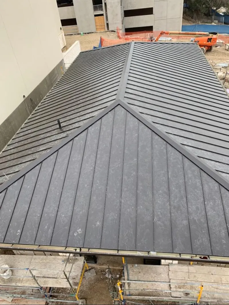 Commercial metal roof construction with crane equipment in Fort Mitchell